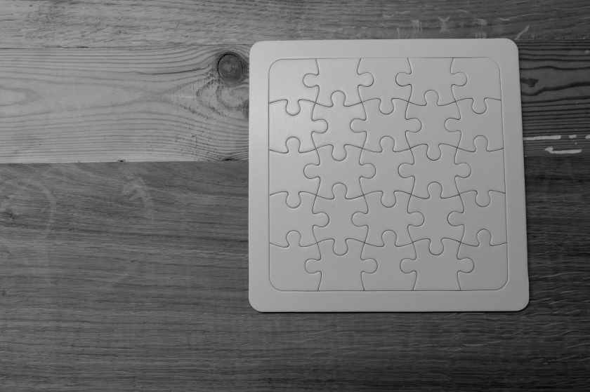 gray scale photo of jigsaw puzzle